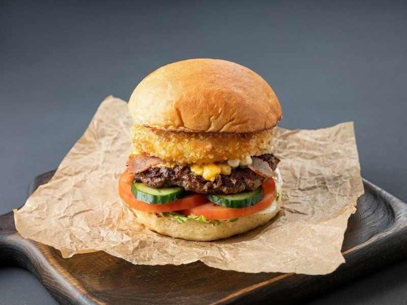 Beef burger with bacon and fresh vegetables